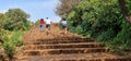 People running up the stairs made with red soil stones at Elphinstone Point, Mahabaleshwar