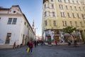 People rushing and walking in a pedestrian street of Brno, Orli Ulice, surrounded by shops and boutiques in the city center