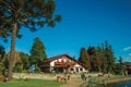 People and rustic house on a park in Gramado