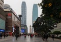 People`s Liberation Monument surrended by tall skyscrapers and buildings with huge LCD screens