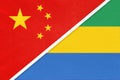 China or PRC vs Gabon national flag from textile. Relationship between Asian and African countries