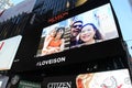People's selfies flashing on marquee,Times Square,NYC,2015