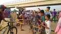 People's who are lifting bicycles, passing the road divider portal