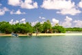 People sailing on the boat on the ocean under the cloudy blue sky Royalty Free Stock Photo