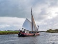 People sailing on old sail barge on Jeltesloot in De Fryske Marren, Friesland, Netherlands