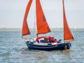 People sailing on sailboat on Waddensea near coast of West Frisian island Ameland, Friesland, Netherlands