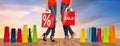 Close up of women with sale sign on shopping bags Royalty Free Stock Photo