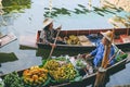 People sale fruit on boat at Damnoen Saduak Floating Market in Thailand.,27 November 2020.,THAILAND