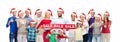 People in santa hats with sale sign at christmas Royalty Free Stock Photo