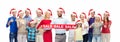 People in santa hats with sale sign at christmas Royalty Free Stock Photo