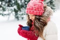 Happy young woman with tea cup in winter park Royalty Free Stock Photo