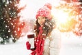 young woman with hot drink in tumbler in winter Royalty Free Stock Photo