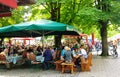 People seat at beer garden in Viktualienmarkt, gourmet point in Munich center