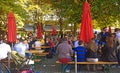 People seat and chat at beer garden in Viktualienmarkt, Munich