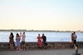 People seated next to the sea