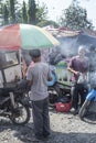 People sell and buy barbecue at Gotong Royong market in Bukit Lawang, Indonesia