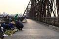People sell fruits on the road for motorbikes on Long Bien old bridge.