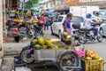 People selling fruits in the street with traditional houses in George Town, Malaysia