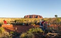 People setting dinner bbq buffet tables at Uluru sunset view point and Ayers rock in background in NT outback Australia