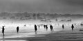 People shadows on a beach at sunset