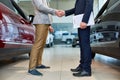 People Shaking Hands in Car Showroom Royalty Free Stock Photo