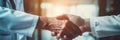 People shaking hands closeup, handshake between doctor and patient, blur room interior background