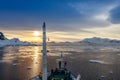 People on the ship& x27;s deck watching the sunset view among iceberg Royalty Free Stock Photo