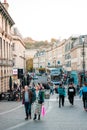 People and shoppers walking around in the Busy downtown area of the Bath Spa, the famous historical city of England