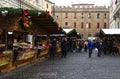 People shopping in French Christmas market in Bologna, Piazza Minghetti, Italy.