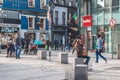 People shopping on Oliver Plunkett St, one of the city`s main streets for stores, street performers, restaurants, and busy city. Royalty Free Stock Photo