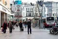 People shopping on Patrick Street in Cork, the city`s main street for stores, street performers, restaurants, and busy city life.