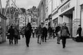 People shopping on Patrick Street in Cork, the main street for stores, street performers, restaurants; photographed in monochrome. Royalty Free Stock Photo