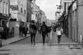 People shopping on Patrick Street in Cork, the main street for stores, street performers, restaurants; photographed in monochrome. Royalty Free Stock Photo
