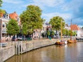 People shopping on quayside of historic harbour in old town of Dokkum, Friesland, Netherlands Royalty Free Stock Photo