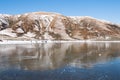 People on the shore of a frozen lake