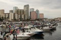 People on the shore line and boats in the water with view of city at the pirate raid during Gasparilla in Tampa, Florida January 2