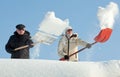 People shovelling snow on a roof Royalty Free Stock Photo