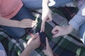 People show signs with their hands and fingers. Young people are sitting in a circle. Communication