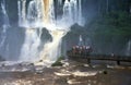 People on a sightseeing platform in front of the roaring waterfalls of Ignazu, Argentinia Royalty Free Stock Photo