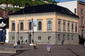 People sightseeing and walking around the Norges bank, Norway's central bank in downtown Bergen