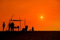 People silhoettes at sunset on a beach