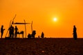 People silhoettes at sunset on a beach Royalty Free Stock Photo