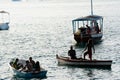 People, in silhouette, are seen having fun on the boats on the beach of the modern art museum