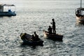 People, in silhouette, are seen having fun on the boats on the beach of the modern art museum