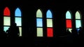 People Silhouetted against stained glass