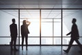 People silhouettes in a dark office room with big panoramic windows. Interior design and meeting room concept Royalty Free Stock Photo