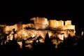 People silhouettes in the foreground, with Acropolis night view at the background