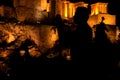 People silhouettes in the foreground, with Acropolis night view at the background