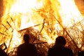 People silhouettes in front of burning fire