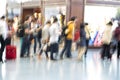People silhouettes in motion blur, airport interior Royalty Free Stock Photo